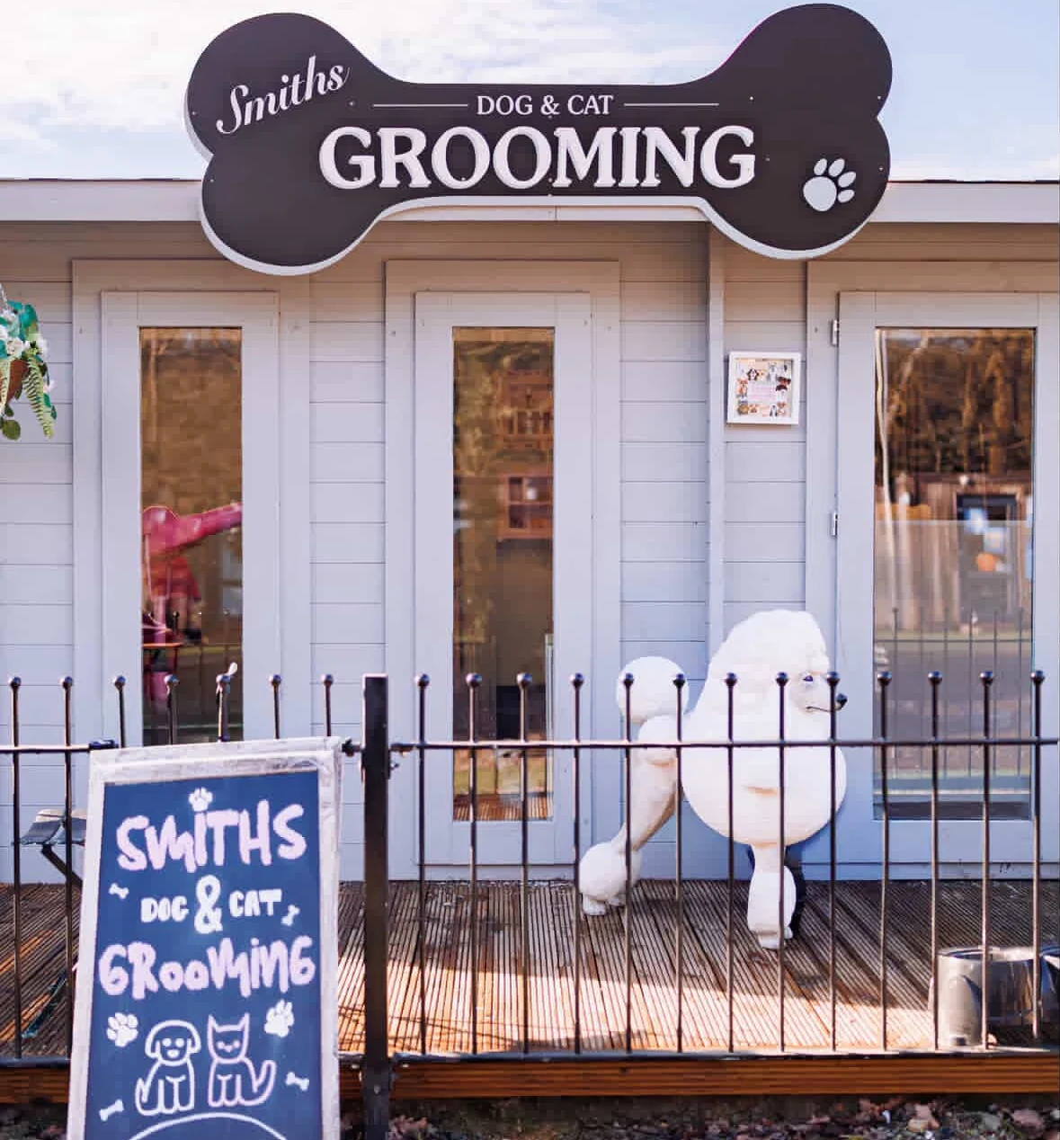The salon at Hunters Chase, with its bone-shaped Smiths sign and a chalkboard of a dog and a cat by the gate